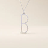 Slim initial letter necklace in 14k solid gold, accented with tiny moissanites for subtle sparkle. A sleek and personal everyday accessory.