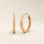 Small minimal hoop earrings in 14k rose gold, featuring a clean and contemporary design.

