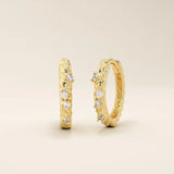 Twist rope hoop earrings in 14k yellow gold, accented with sparkling moissanite stones.
