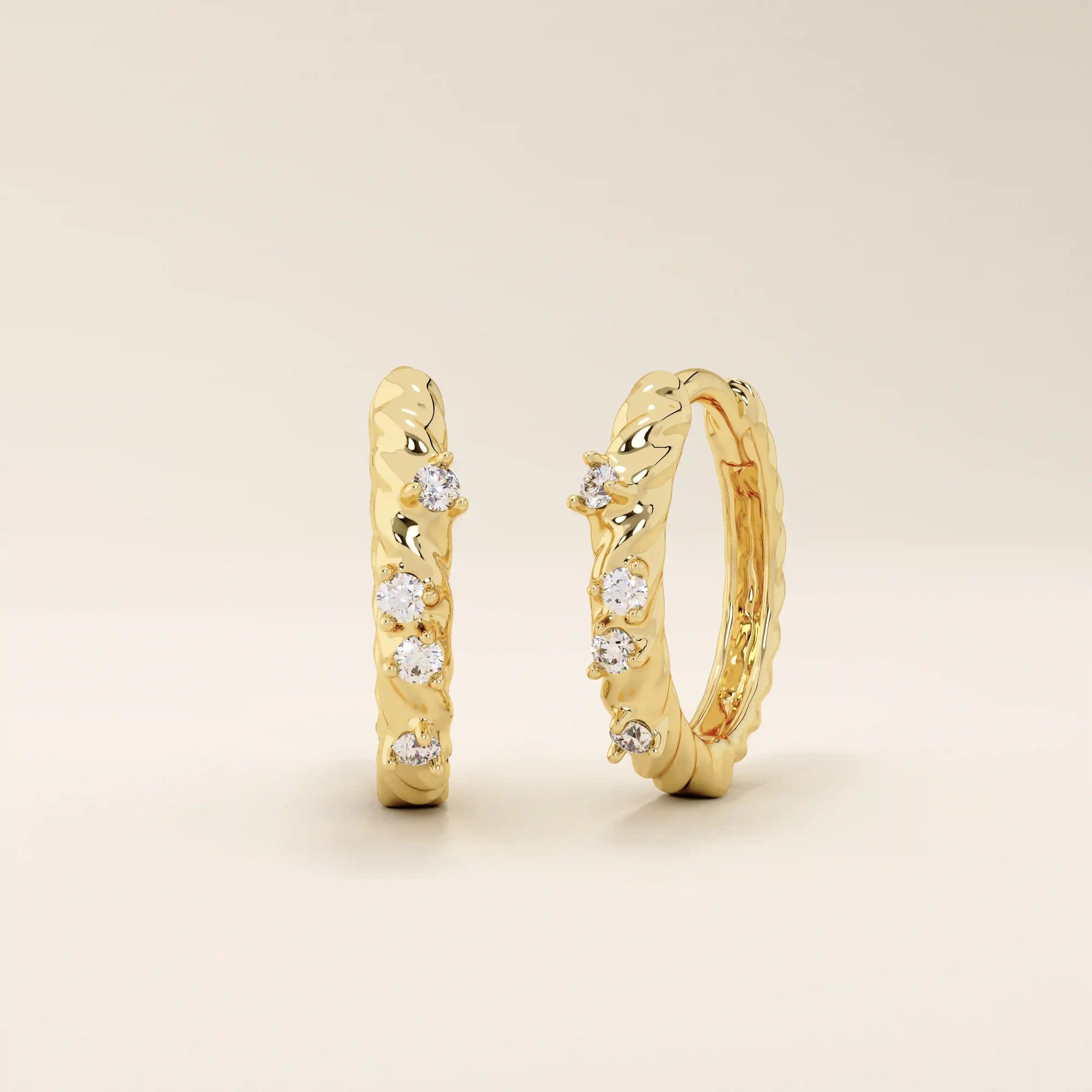 Twist rope hoop earrings in 14k yellow gold, accented with sparkling moissanite stones.
