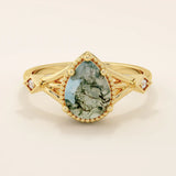 Vintage-inspired 14k gold ring featuring a pear cut natural moss agate. Unique gemstone anniversary ring with organic patterns.