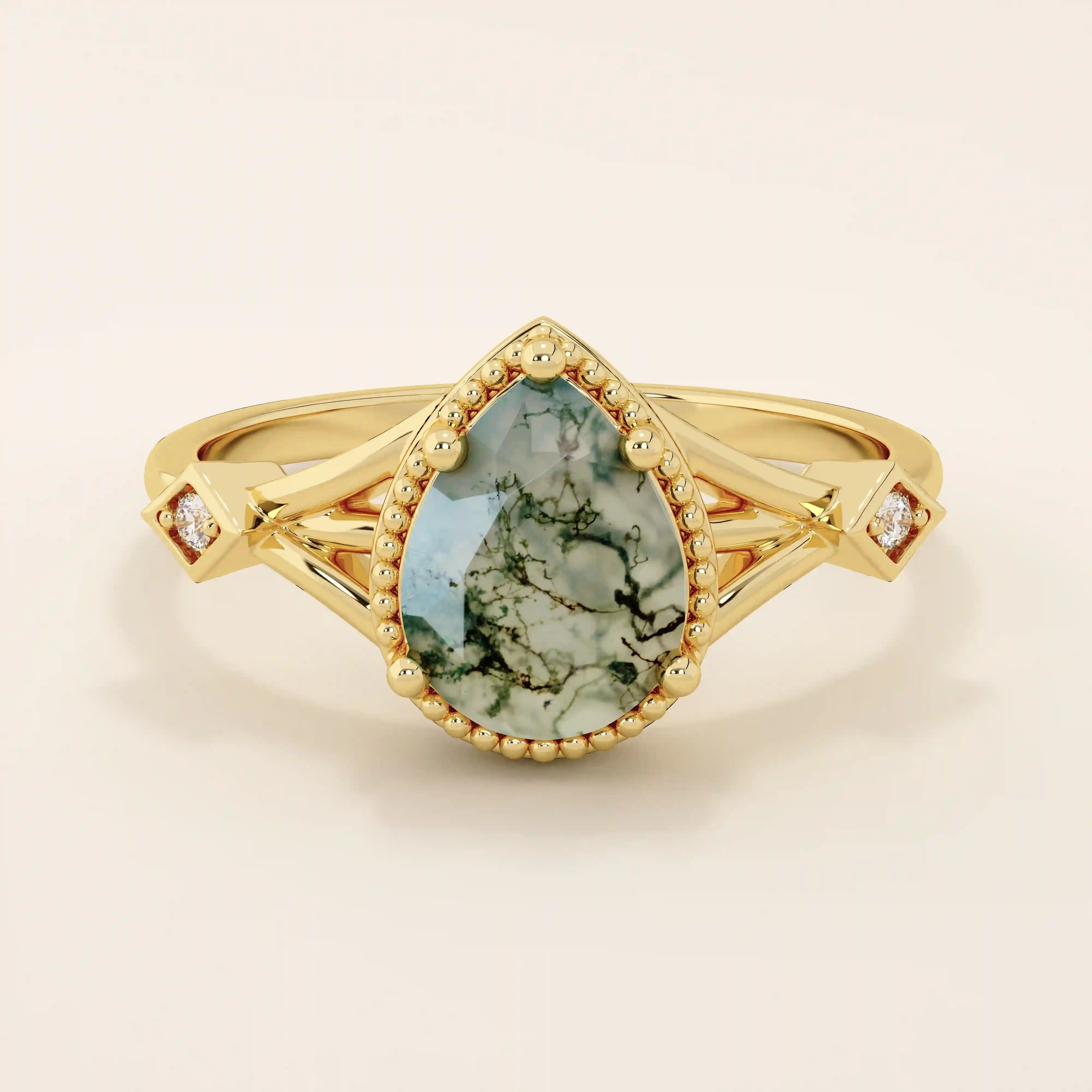 Vintage-inspired 14k gold ring featuring a pear cut natural moss agate. Unique gemstone anniversary ring with organic patterns.