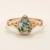 Vintage-inspired 14k gold ring featuring a pear cut natural moss agate. Unique gemstone anniversary ring with organic patterns.