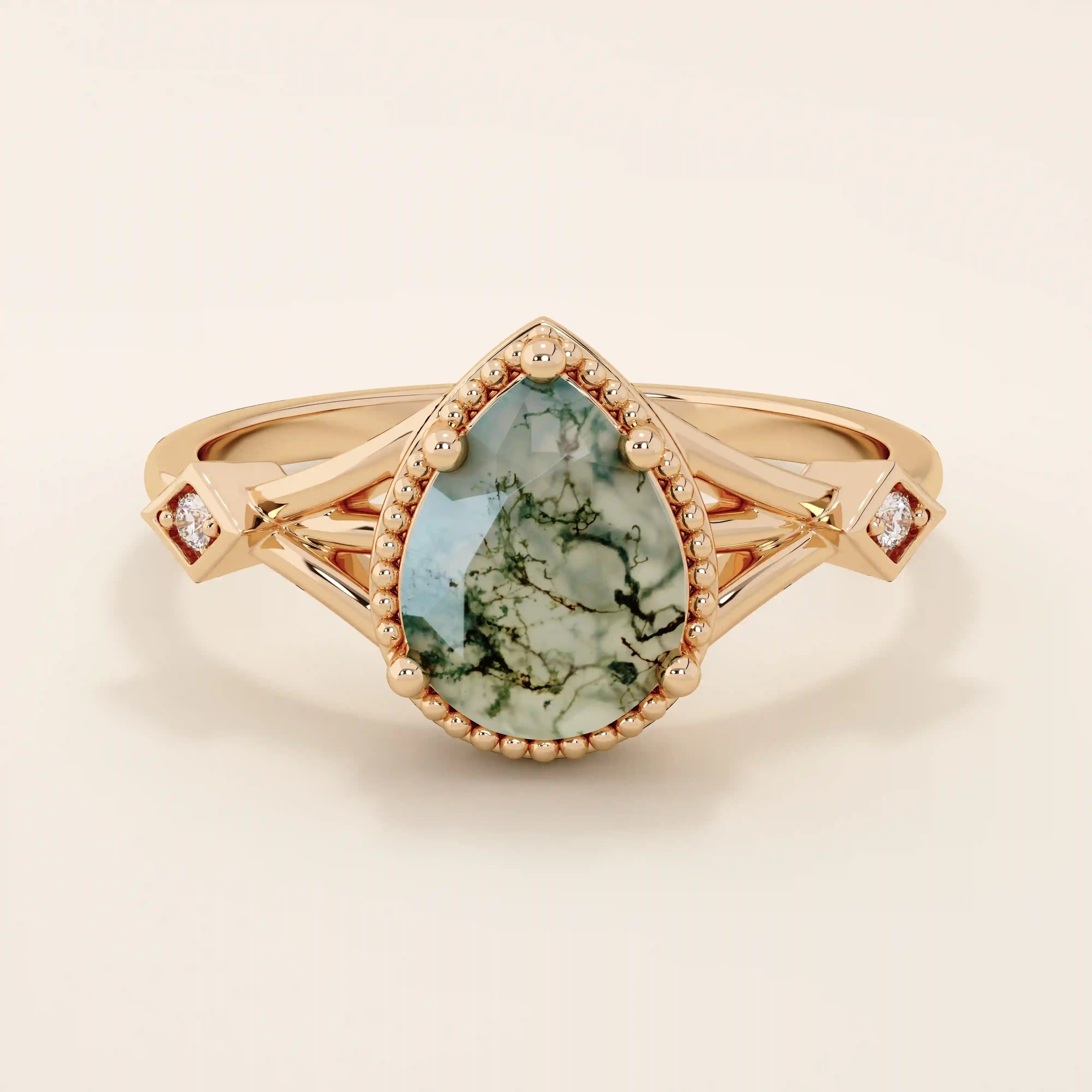 Vintage-inspired 14k gold ring featuring a pear cut natural moss agate. Unique gemstone anniversary ring with organic patterns.