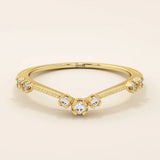 Vintage-inspired slim curved stacking ring in 14k solid gold featuring tiny moissanites set on a milgrain textured band. Elegant and detailed design perfect for layering.