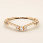 Vintage-inspired slim curved stacking ring in 14k solid gold featuring tiny moissanites set on a milgrain textured band. Elegant and detailed design perfect for layering.