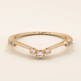 Vintage-inspired slim curved stacking ring in 14k solid gold featuring tiny moissanites set on a milgrain textured band. Elegant and detailed design perfect for layering.