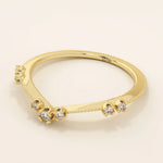 Vintage-inspired slim curved stacking ring in 14k solid gold featuring tiny moissanites set on a milgrain textured band. Elegant and detailed design perfect for layering.