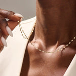 Woman wearing a 14k solid gold lip chain necklace with smooth, rounded links. A bold yet minimal piece for daily style. Perfect as a statement chain or base layer.