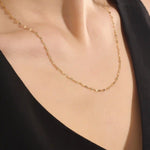 Woman wearing a 14k solid gold lip chain necklace with smooth, rounded links. A bold yet minimal piece for daily style. Perfect as a statement chain or base layer.