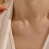 Woman wearing a 14k solid gold mixed metal bar chain necklace with polished yellow and white gold segments. A unique, eye-catching design for daily looks. Great for bold layering or worn alone.