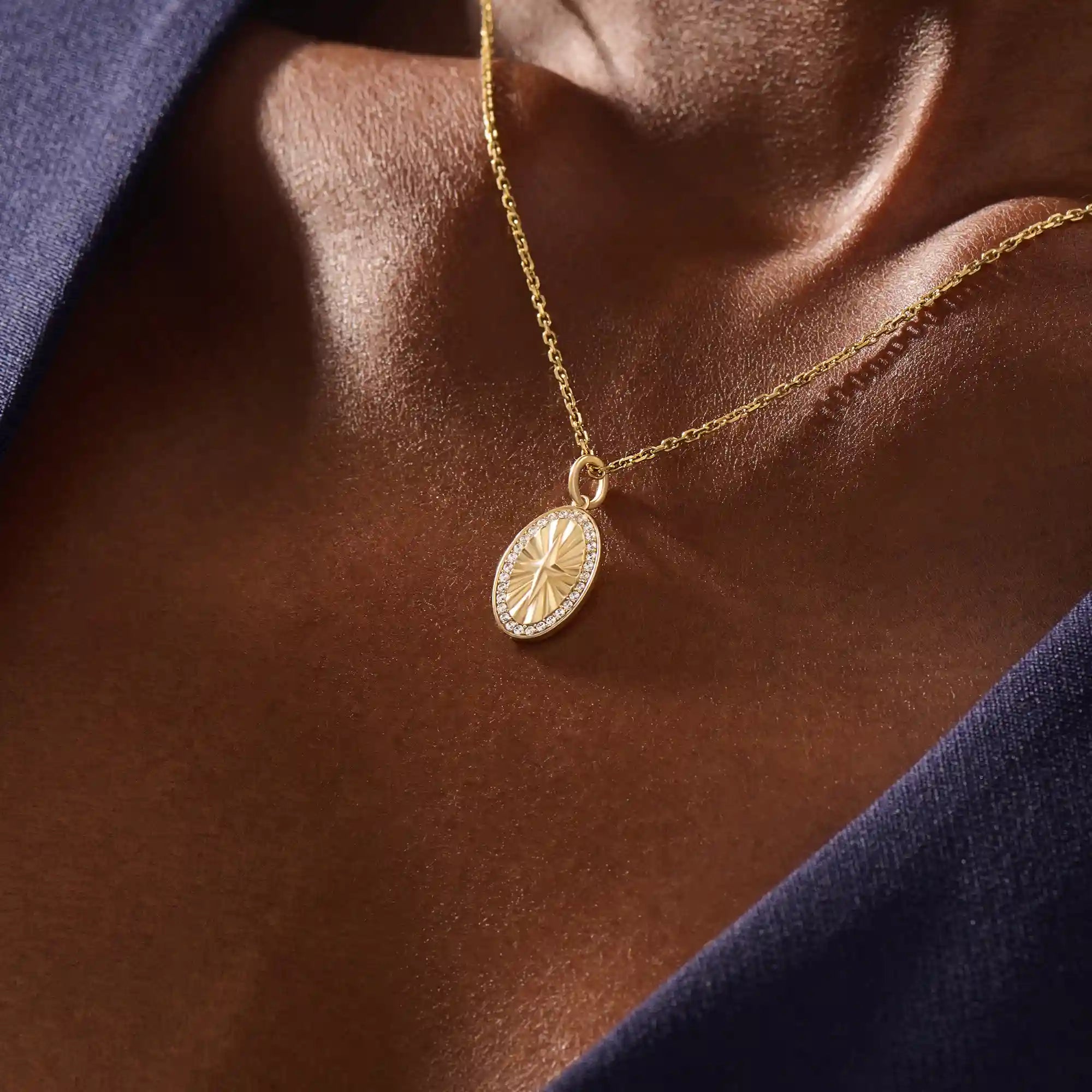 Woman wearing a 14k solid gold oval compass necklace featuring pave moissanite accents and a central 4-point star. Minimalist and meaningful pendant necklace. Ideal for layering or gifting.
