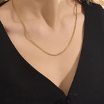 Woman wearing a 14k solid gold rolo chain necklace with smooth round links. A simple yet bold chain for daily outfits. Ideal for layering or wearing solo.