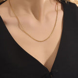 Woman wearing a 14k solid gold rolo chain necklace with smooth round links. A simple yet bold chain for daily outfits. Ideal for layering or wearing solo.