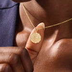 Woman wearing a 14k solid gold rose pendant necklace with delicate moissanite details. Floral-inspired minimalist jewelry styled for everyday. A timeless gold necklace for women.