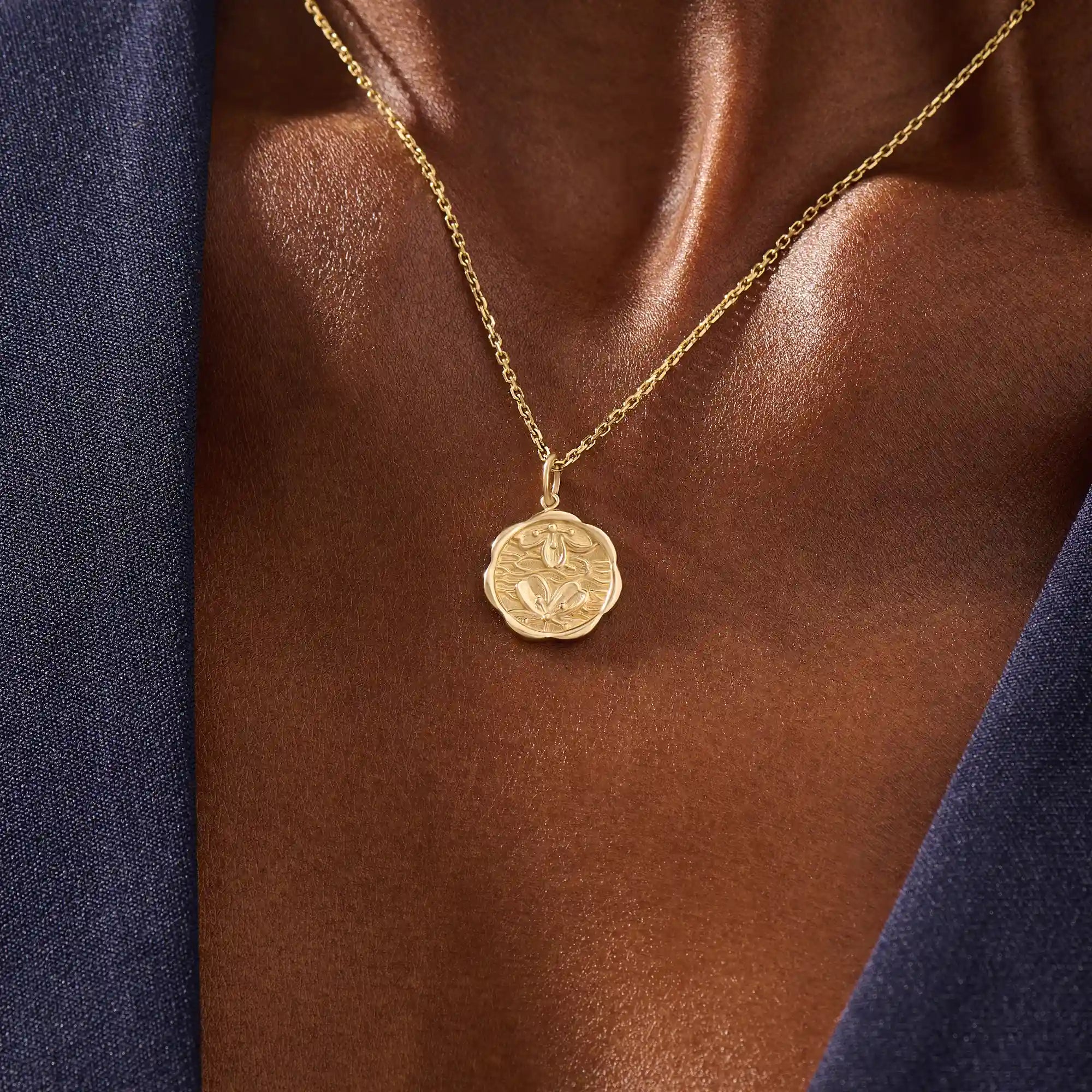 Woman wearing a 14k solid gold round necklace with a Sakura flower motif. Elegant floral-inspired jewelry for women. Perfect for everyday gold layering.