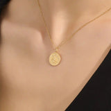 Woman wearing a 14k solid gold water lily pendant necklace with a delicate moissanite accent. Nature-inspired fine jewelry styled for everyday wear. Elegant and minimalist gold necklace for women.