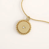 14k gold vermeil beaded coin necklace featuring a round polished pendant framed with delicate beaded detailing and a central star-set cubic zirconia for subtle brilliance.
