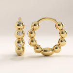 14k gold vermeil beaded hoop earrings featuring a row of polished spherical beads accented with sparkling cubic zirconia, blending texture and shine for an elegant look.
