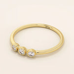 three bezel-set sparkling stones in brilliant 14k solid yellow gold slim band wedding stacking ring for women