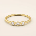 three bezel-set sparkling stones in brilliant 14k solid yellow gold slim band wedding stacking ring for women