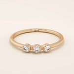 three bezel-set sparkling stones in brilliant 14k solid yellow gold slim band wedding stacking ring for women