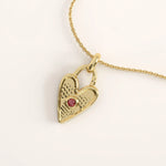 14k gold vermeil birthstone heart necklace featuring a textured heart-shaped lock pendant adorned with a round gemstone accent for a personalized touch.
