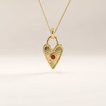 14k gold vermeil birthstone heart necklace featuring a textured heart-shaped lock pendant adorned with a round gemstone accent for a personalized touch.
