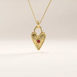 14k gold vermeil birthstone heart necklace featuring a textured heart-shaped lock pendant adorned with a round gemstone accent for a personalized touch.
