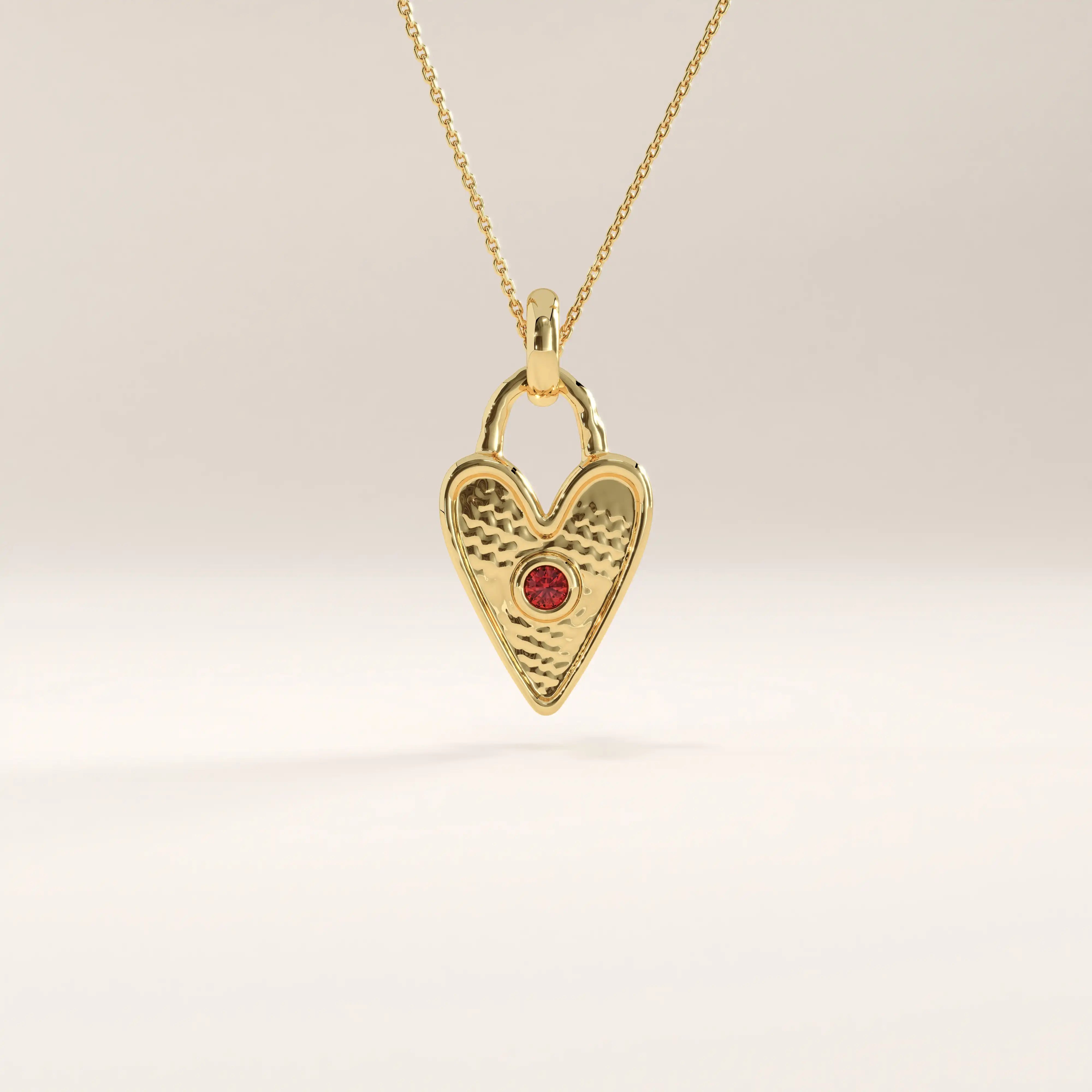 14k gold vermeil birthstone heart necklace featuring a textured heart-shaped lock pendant adorned with a round gemstone accent for a personalized touch.
