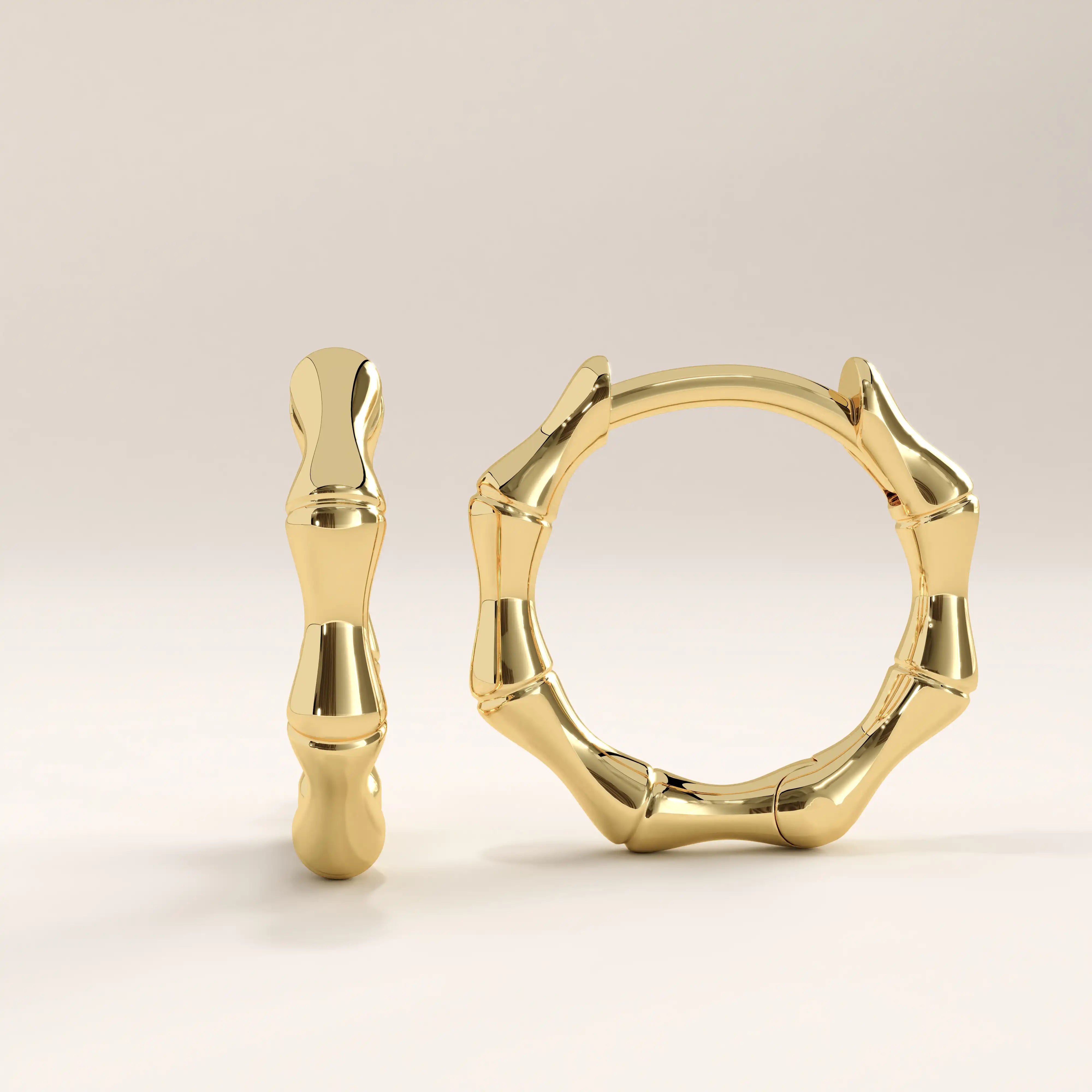 14k gold vermeil bone hoop earrings featuring an organic sculptural design inspired by natural bone shapes, blending modern artistry with timeless shine.
