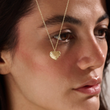 Model wearing a 14k gold vermeil 3D heart necklace featuring a sculpted heart pendant with soft curves and a delicate cubic zirconia accent for a graceful, contemporary look.
