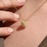 Model wearing a 14k gold vermeil 3D heart necklace featuring a sculpted heart pendant with soft curves and a delicate cubic zirconia accent for a graceful, contemporary look.

