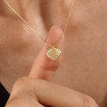 Model wearing a 14k gold vermeil 3D heart necklace featuring a sculpted heart pendant with soft curves and a delicate cubic zirconia accent for a graceful, contemporary look.
