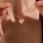 Model wearing a 14k gold vermeil 3D heart necklace featuring a sculpted heart pendant with soft curves and a delicate cubic zirconia accent for a graceful, contemporary look.
