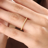 Model wearing a 14k gold vermeil beaded band ring featuring perfectly rounded beads that create a classic, timeless silhouette with radiant luster.
