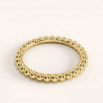 Side view of 14k gold vermeil beaded band ring highlighting its seamless spherical detailing and mirror-like shine.
