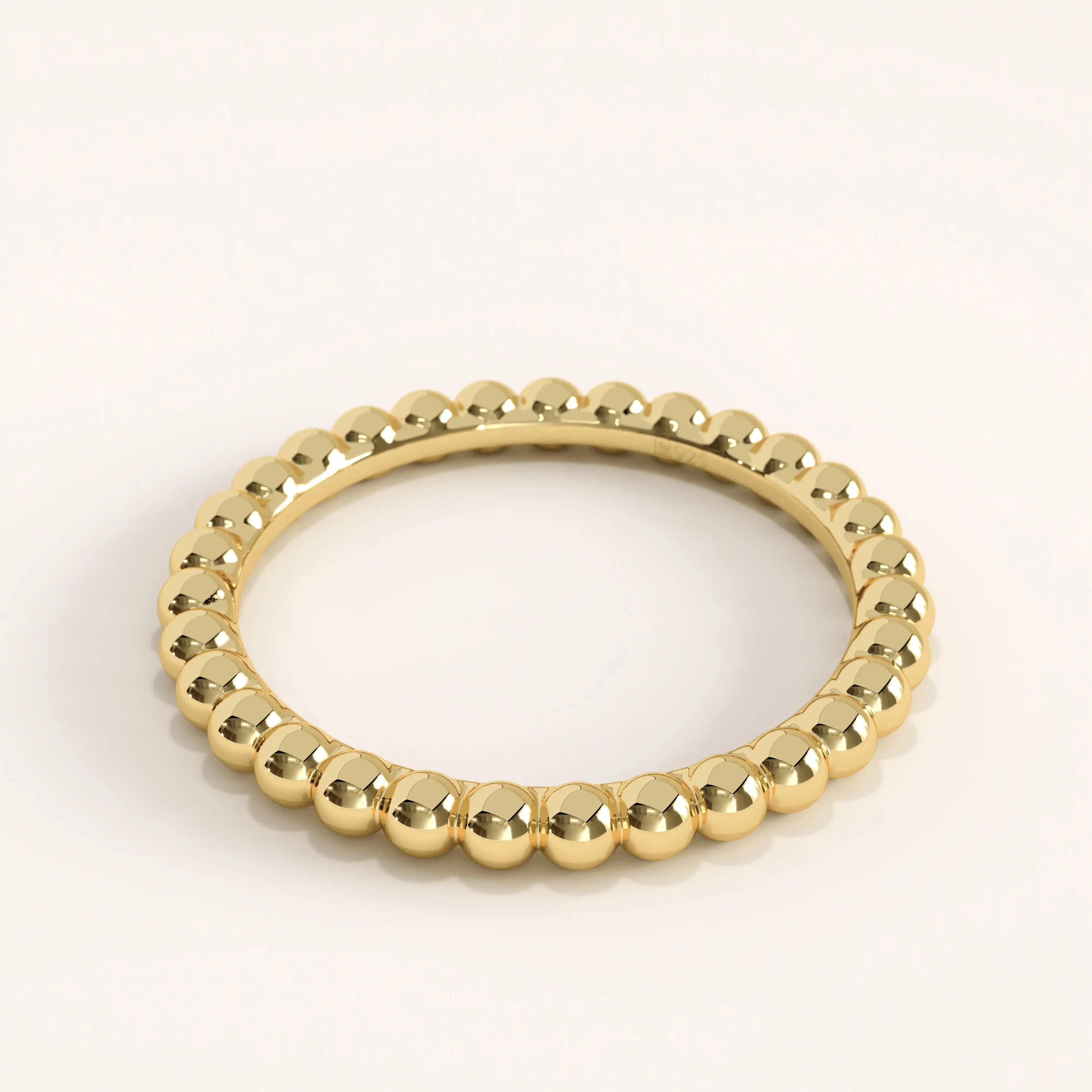 Side view of 14k gold vermeil beaded band ring highlighting its seamless spherical detailing and mirror-like shine.

