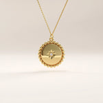 Side view of 14k gold vermeil beaded coin necklace highlighting the intricate bead-edge texture and central stone setting that enhance its elegant craftsmanship.
