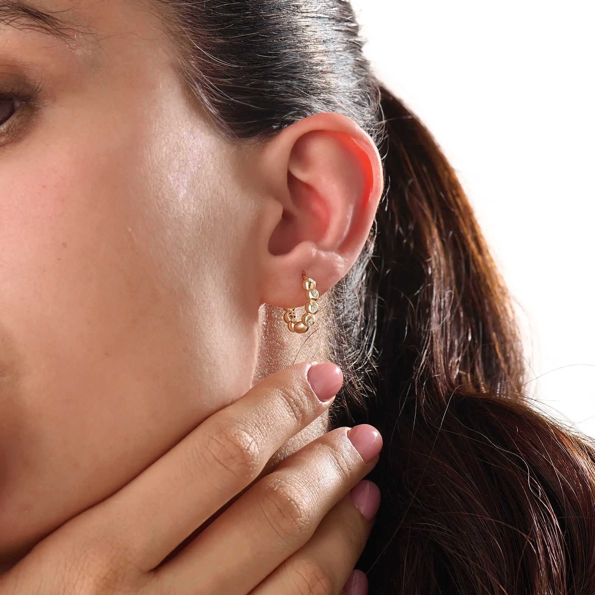 Model wearing 14k gold vermeil beaded hoop earrings showcasing the radiant beaded design and subtle shimmer, perfect for everyday elegance or evening wear.
