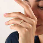 Model wearing a 14k gold vermeil beaded trio ring featuring three round cubic zirconia stones, adding a subtle sparkle to a modern everyday look.
