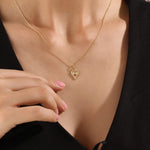 Model wearing a 14k gold vermeil birthstone heart necklace featuring a unique heart lock pendant with a colored gemstone accent for a sentimental, stylish statement.
