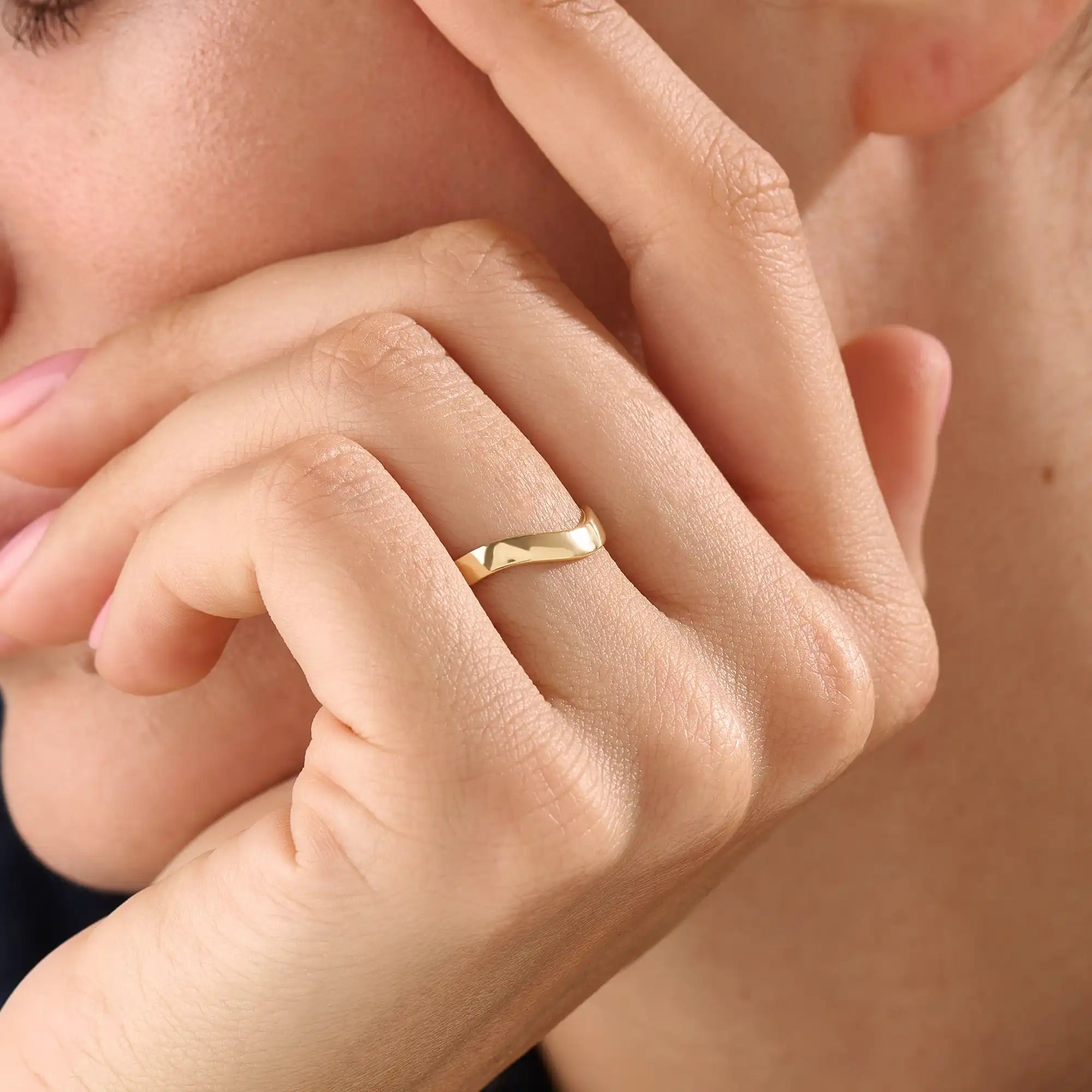 Model wearing a 14k gold vermeil curve band ring with a softly curved design, showcasing a timeless minimalist style for women.
