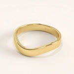 Side angle of 14k gold vermeil curve band ring showing the smooth contoured shape and reflective surface.
