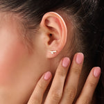 Model wearing 14k gold vermeil curvy marquise earrings highlighting the sculpted form and shimmering marquise stone that add refined allure to any outfit.
