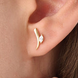 Model wearing 14k gold vermeil curvy marquise earrings highlighting the sculpted form and shimmering marquise stone that add refined allure to any outfit.
