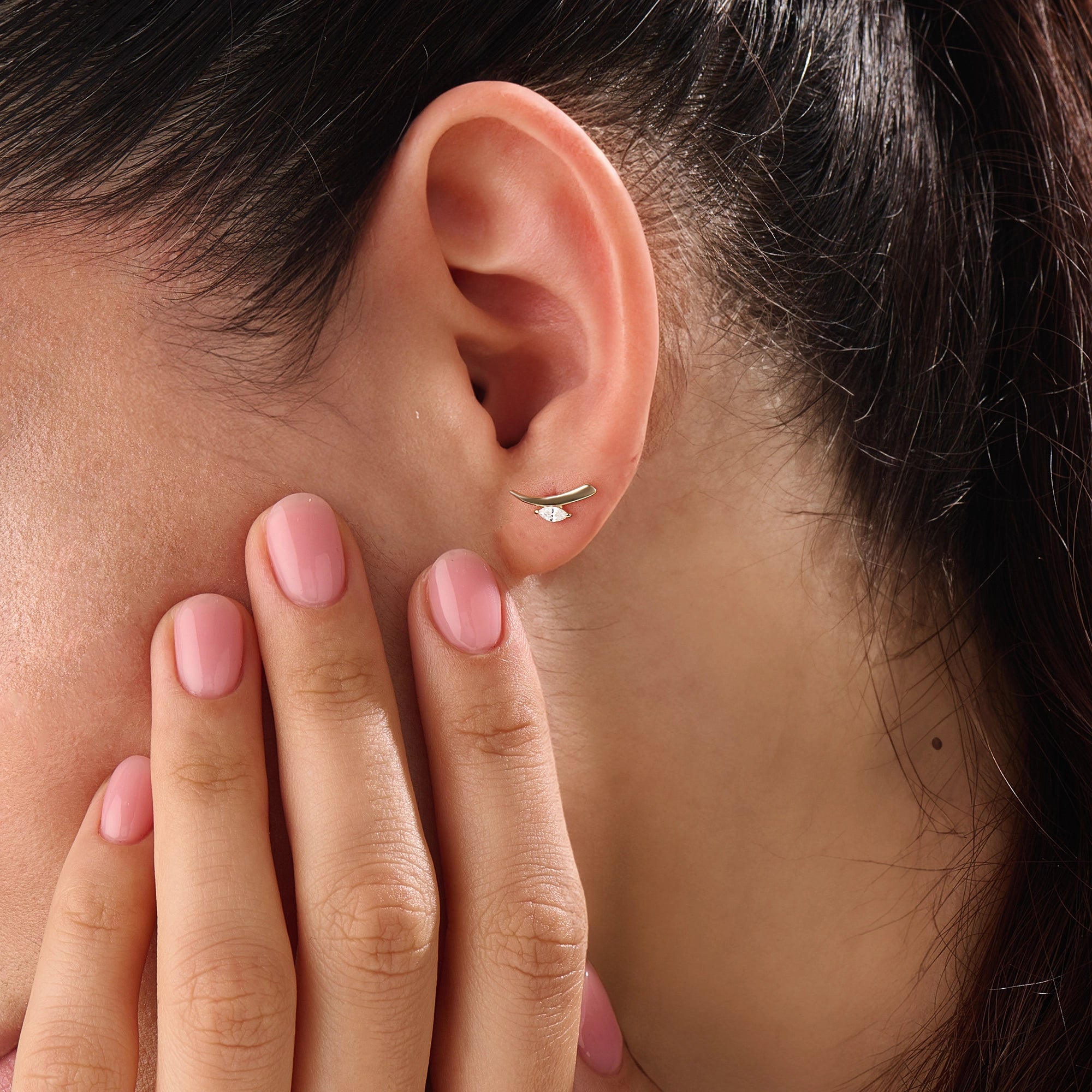 Model wearing 14k gold vermeil curvy marquise earrings highlighting the sculpted form and shimmering marquise stone that add refined allure to any outfit.
