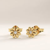 Side view of 14k gold vermeil daisy stud earrings highlighting the dimensional petal structure and lustrous finish for a soft, feminine shine.
