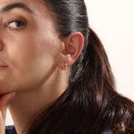 Model wearing 14k gold vermeil dome hoop earrings showcasing their bold, sculptural shape and radiant gold tone — perfect for elevating any outfit from day to night.
