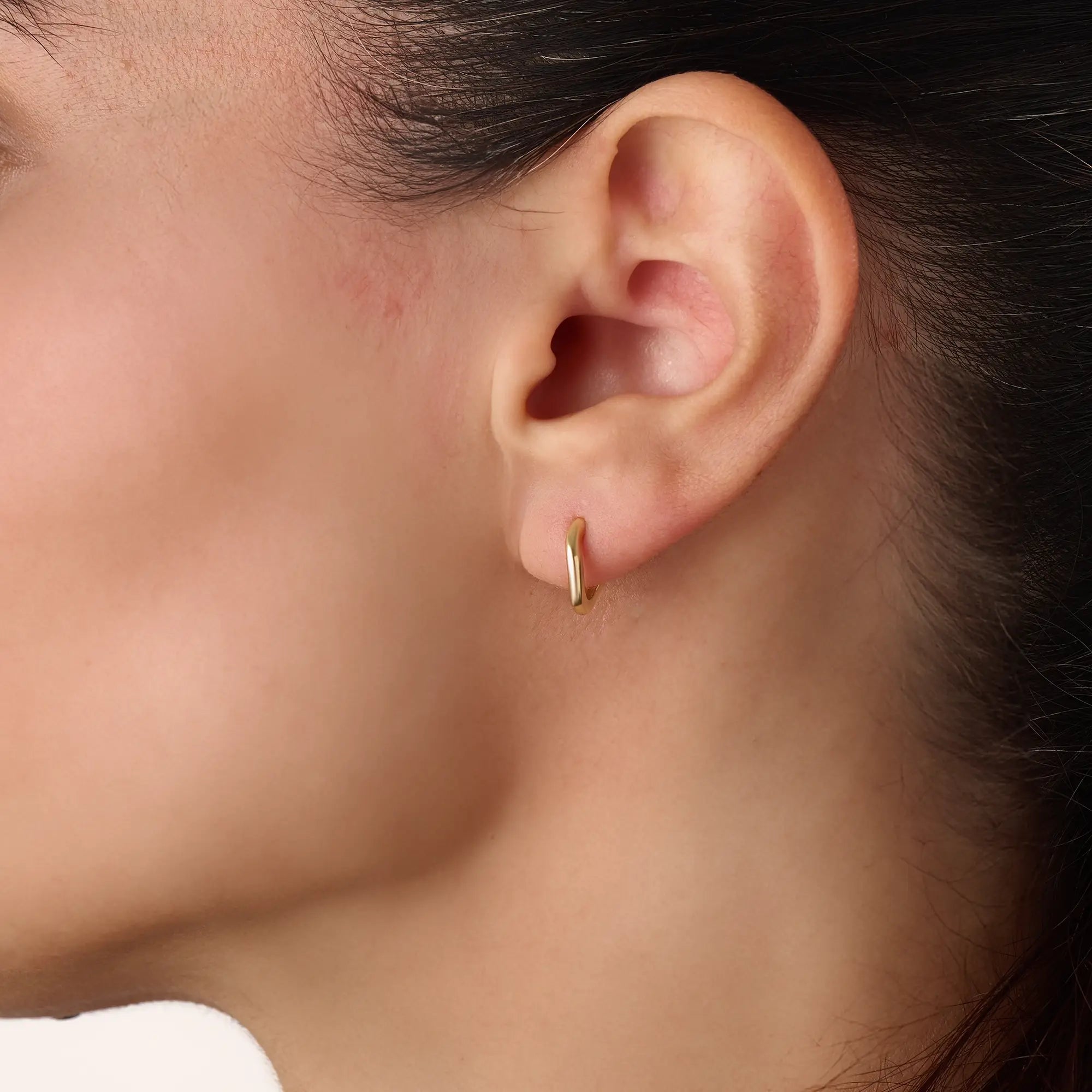 Model wearing 14k gold vermeil dome hoop earrings showcasing their bold, sculptural shape and radiant gold tone — perfect for elevating any outfit from day to night.
